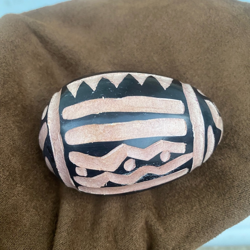 Artistic Black and Tan Oval carved Stone